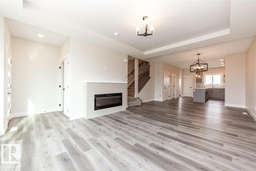 201 Caledonia Drive, Leduc, AB - Indoor Photo Showing Living Room With Fireplace