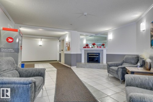110 8315 83 Street Nw, Edmonton, AB - Indoor Photo Showing Living Room With Fireplace