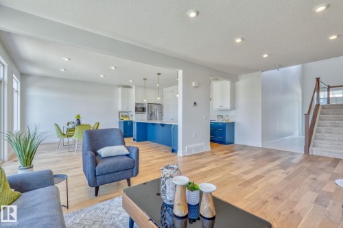 Living room featuring light wood-style floors, recessed lighting, and a textured ceiling - 8320 Mayday Link Sw, Edmonton, AB - Indoor Photo Showing Living Room