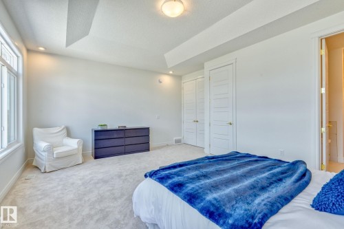 Carpeted bedroom with a closet, recessed lighting, and a textured ceiling - 8320 Mayday Link Sw, Edmonton, AB - Indoor Photo Showing Bedroom