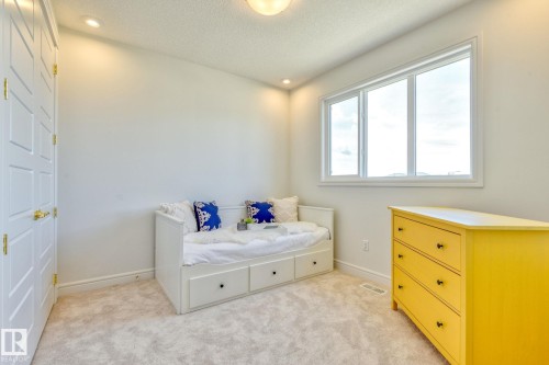 Bedroom featuring a textured ceiling, light colored carpet, and recessed lighting - 8320 Mayday Link Sw, Edmonton, AB - Indoor