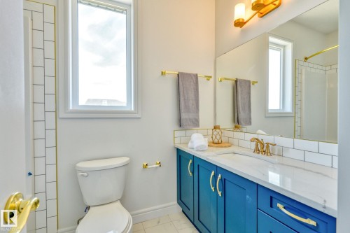 Bathroom featuring vanity and a shower - 8320 Mayday Link Sw, Edmonton, AB - Indoor Photo Showing Bathroom