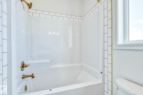 Bathroom with bathtub / shower combination - 8320 Mayday Link Sw, Edmonton, AB - Indoor Photo Showing Bathroom