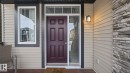 Entrance to property featuring stone siding - 8320 Mayday Link Sw, Edmonton, AB  - Outdoor With Exterior 