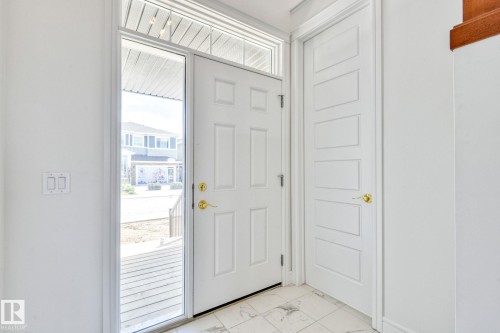 Foyer with light marble finish floors - 8320 Mayday Link Sw, Edmonton, AB - Indoor Photo Showing Other Room