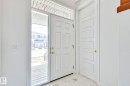 Foyer with light marble finish floors - 8320 Mayday Link Sw, Edmonton, AB  - Indoor Photo Showing Other Room 