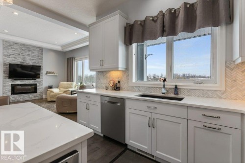 3698 Hummingbird Way, Edmonton, AB - Indoor Photo Showing Kitchen With Fireplace