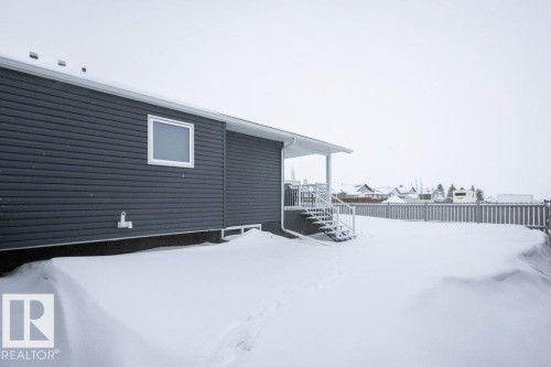 Yard layered in snow featuring a deck - 11116 103 Street, Westlock, AB - Outdoor With Exterior