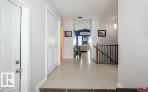 Hallway with an upstairs landing and baseboards - 11116 103 Street, Westlock, AB - Indoor Photo Showing Other Room