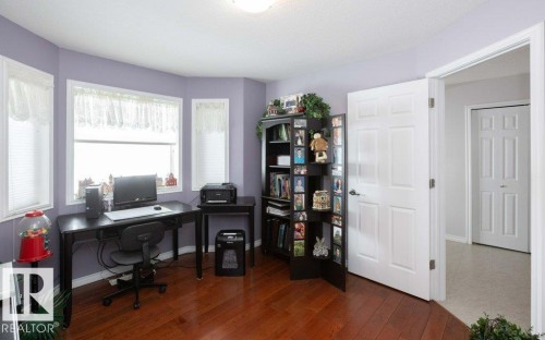Office area with dark wood-style floors and baseboards - 11116 103 Street, Westlock, AB - Indoor Photo Showing Office