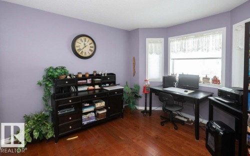 Office area with dark wood-style flooring and baseboards - 11116 103 Street, Westlock, AB - Indoor Photo Showing Office