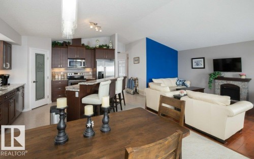 Dining area with a fireplace and vaulted ceiling - 11116 103 Street, Westlock, AB - Indoor