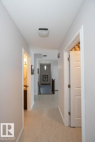 Corridor featuring an upstairs landing and a textured ceiling - 11116 103 Street, Westlock, AB - Indoor Photo Showing Other Room