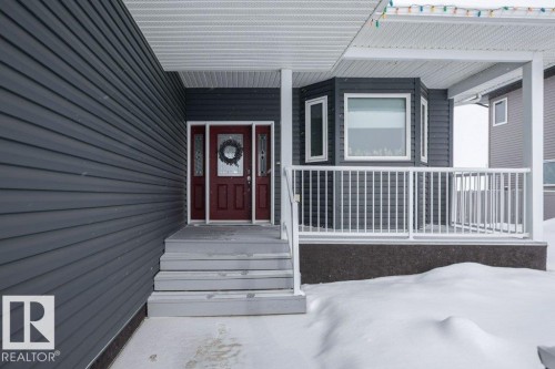 Doorway to property featuring a porch - 11116 103 Street, Westlock, AB - Outdoor With Deck Patio Veranda