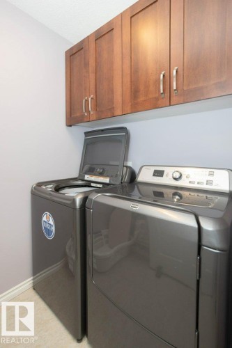 Laundry room featuring cabinet space and separate washer and dryer - 11116 103 Street, Westlock, AB - Indoor Photo Showing Laundry Room