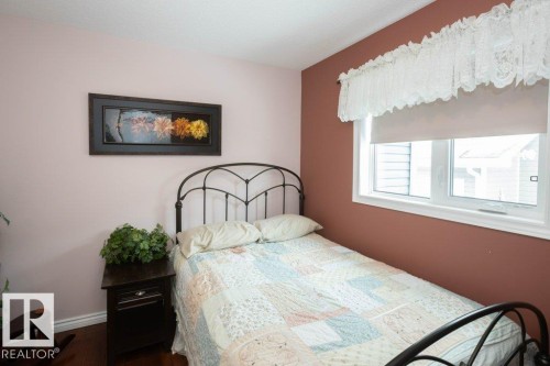 Bedroom featuring baseboards and dark wood-style flooring - 11116 103 Street, Westlock, AB - Indoor Photo Showing Bedroom
