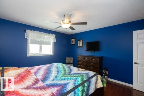 Bedroom featuring dark wood-style flooring and a ceiling fan - 11116 103 Street, Westlock, AB - Indoor Photo Showing Bedroom