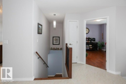 Corridor with an upstairs landing and baseboards - 11116 103 Street, Westlock, AB - Indoor Photo Showing Other Room