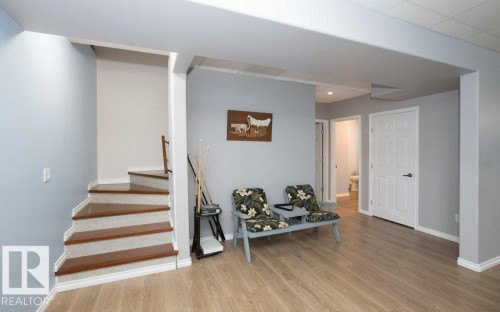 Stairs featuring baseboards and wood finished floors - 11116 103 Street, Westlock, AB - Indoor Photo Showing Other Room