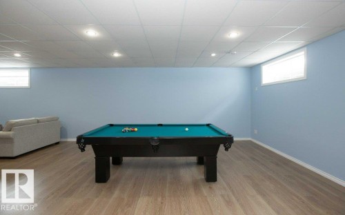 Game room with billiards, healthy amount of natural light, light wood-style floors, recessed lighting, and a paneled ceiling - 11116 103 Street, Westlock, AB - Indoor Photo Showing Other Room