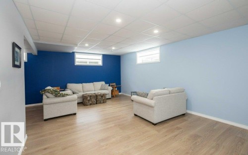 Living room featuring light wood-style floors, a drop ceiling, and recessed lighting - 11116 103 Street, Westlock, AB - Indoor Photo Showing Basement