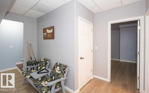 Hallway featuring light wood-type flooring and a drop ceiling - 11116 103 Street, Westlock, AB - Indoor Photo Showing Other Room