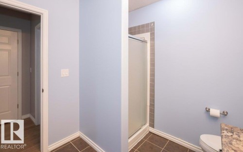 Full bathroom with a stall shower and dark tile patterned flooring - 11116 103 Street, Westlock, AB - Indoor Photo Showing Bathroom