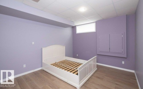 Unfurnished bedroom with light wood-type flooring and a drop ceiling - 11116 103 Street, Westlock, AB - Indoor Photo Showing Bedroom