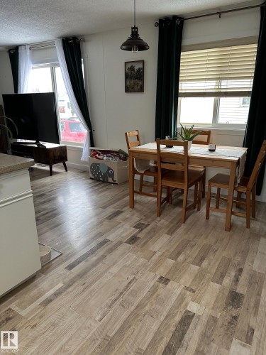 Dining room with light wood-style floors and a textured ceiling - 341 West Brook Way Nw, Edmonton, AB - Indoor Photo Showing Dining Room