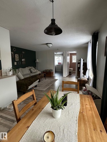 Dining room with a textured ceiling and wood finished floors - 341 West Brook Way Nw, Edmonton, AB - Indoor