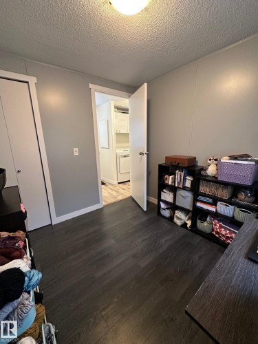 Office space with dark wood-type flooring and a textured ceiling - 341 West Brook Way Nw, Edmonton, AB - Indoor