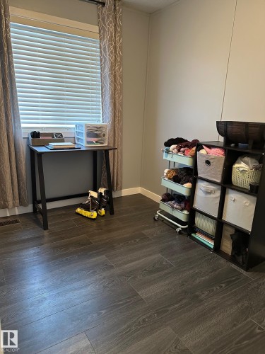 Office space featuring dark wood finished floors and baseboards - 341 West Brook Way Nw, Edmonton, AB - Indoor