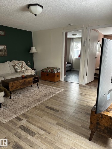 Sitting room featuring light wood finished floors and a textured ceiling - 341 West Brook Way Nw, Edmonton, AB - Indoor