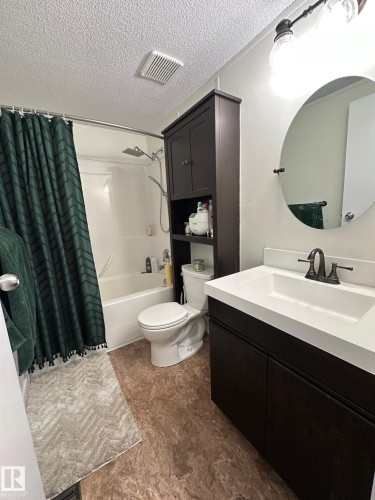 Full bathroom with vanity, shower / bath combo, and a textured ceiling - 341 West Brook Way Nw, Edmonton, AB - Indoor Photo Showing Bathroom