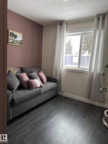 Bedroom featuring a textured ceiling and dark wood-style floors - 341 West Brook Way Nw, Edmonton, AB - Indoor Photo Showing Bedroom