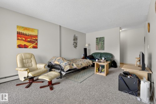 Carpeted bedroom with a textured ceiling - 302 4608 52 Avenue, Stony Plain, AB - Indoor