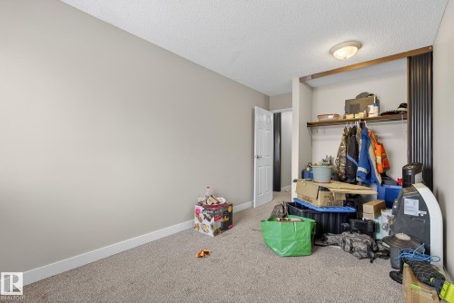 Bedroom with carpet floors and a textured ceiling - 307 4608 52 Avenue, Stony Plain, AB - Indoor Photo Showing Other Room