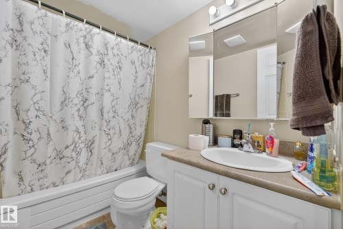 Full bath featuring vanity and shower / bath combo with shower curtain - 307 4608 52 Avenue, Stony Plain, AB - Indoor Photo Showing Bathroom