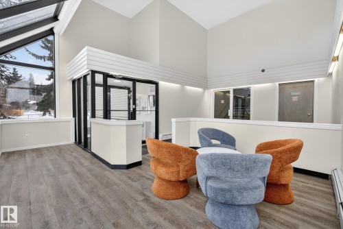 Living area with lofted ceiling and a baseboard heating unit - 307 4608 52 Avenue, Stony Plain, AB - Indoor Photo Showing Other Room