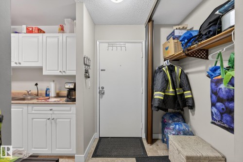 Laundry room with a textured ceiling and a sink - 307 4608 52 Avenue, Stony Plain, AB - Indoor Photo Showing Other Room