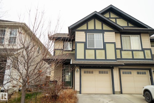 View of front of property with a shingled roof, driveway, and an attached garage - Edmonton, AB - Outdoor