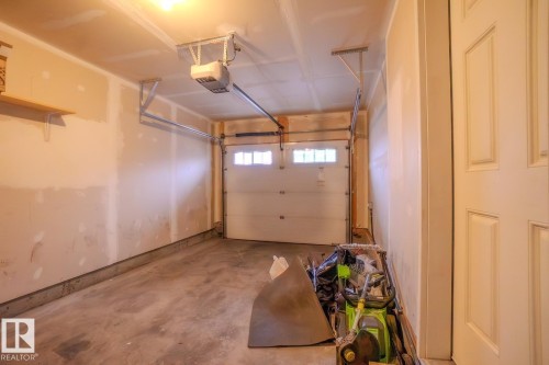 Garage with a garage door opener - Edmonton, AB - Indoor Photo Showing Garage