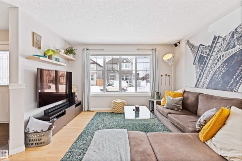 Living area with light wood-type flooring and a textured ceiling - 7804 Schmid Place, Edmonton, AB - Indoor Photo Showing Bedroom