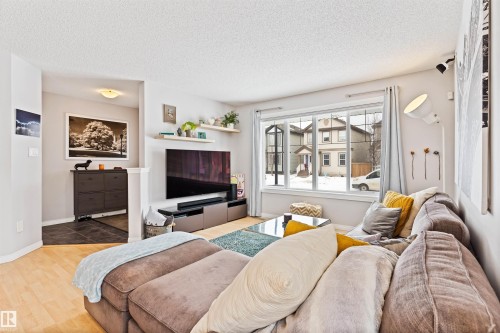 Living room with light wood-style floors and a textured ceiling - 7804 Schmid Place, Edmonton, AB - Indoor Photo Showing Living Room