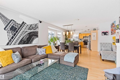 Living room featuring light wood-style floors and a textured ceiling - 7804 Schmid Place, Edmonton, AB - Indoor Photo Showing Living Room