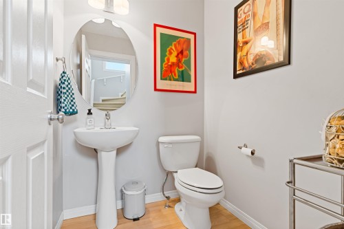 Bathroom with toilet and light wood-type flooring - 7804 Schmid Place, Edmonton, AB - Indoor Photo Showing Bathroom