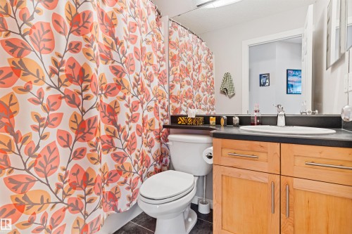 Full bath with a shower with curtain, vanity, and dark tile patterned flooring - 7804 Schmid Place, Edmonton, AB - Indoor Photo Showing Bathroom