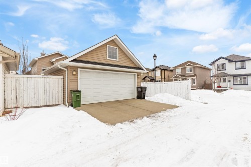 View of front of house featuring a residential view and a garage - 7804 Schmid Place, Edmonton, AB - Outdoor