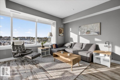 Living area featuring light wood-type flooring and baseboards - 301 2504 109 Street, Edmonton, AB - Indoor Photo Showing Living Room