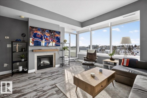 Living room with wood finished floors and a fireplace - 301 2504 109 Street, Edmonton, AB - Indoor Photo Showing Living Room With Fireplace